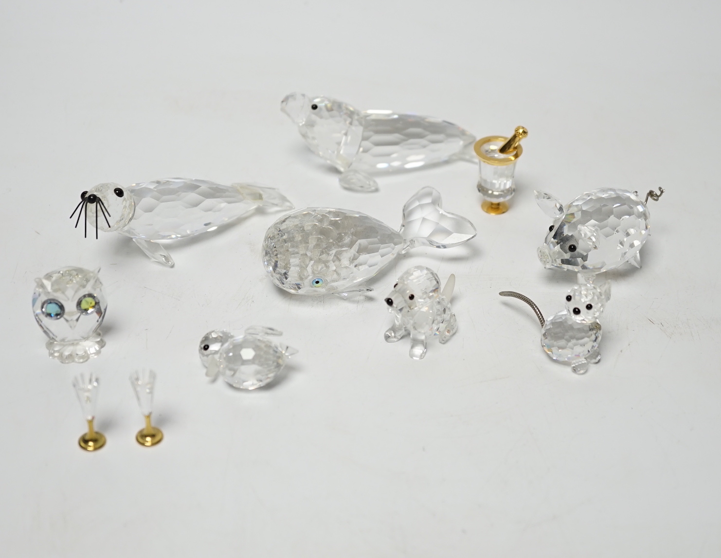 Eight Swarovski crystal animal ornaments and a miniature set of a Champagne cooler and two Champagne glass flutes, (11)